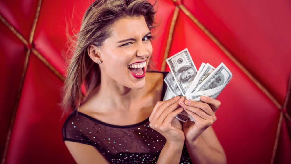 A woman holding a wad of money