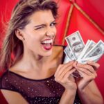 A woman holding a wad of money