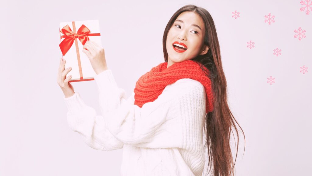 A woman holding a holiday gift