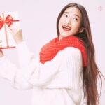 A woman holding a holiday gift