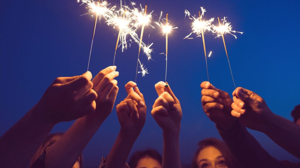 women holding sparklers