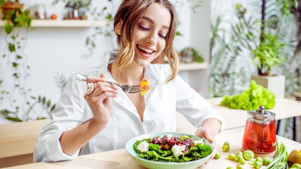 a healthy woman eating a salad