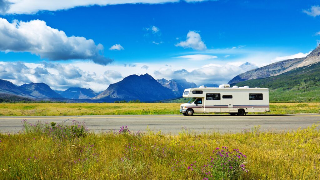 an rv driving through glacier national park