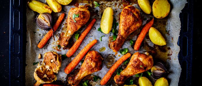 fh-inblog-sheetpan-chicken-carrots-potatoes Cheap meal ideas like roasted chicken drumsticks with carrots, potatoes, onions, and garlic on a sheet pan.