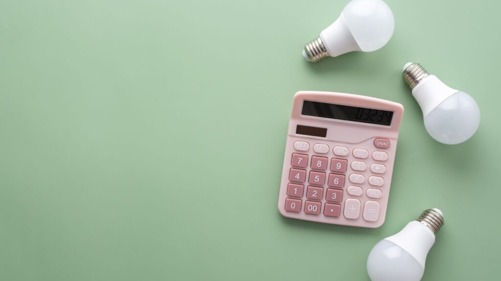 three led bulbs next to a pink calculator