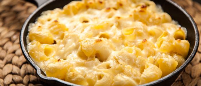 a cast iron pan filled with baked macaroni and cheese