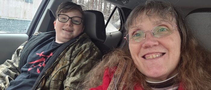 Frugal Hen Beth Casey, and son Gabe smiling in the car before heading to a sugar house visit during Maple Weekend.